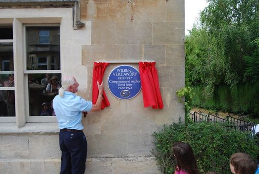 Christopher Awdry beside the commemorative plaque at Lorne House