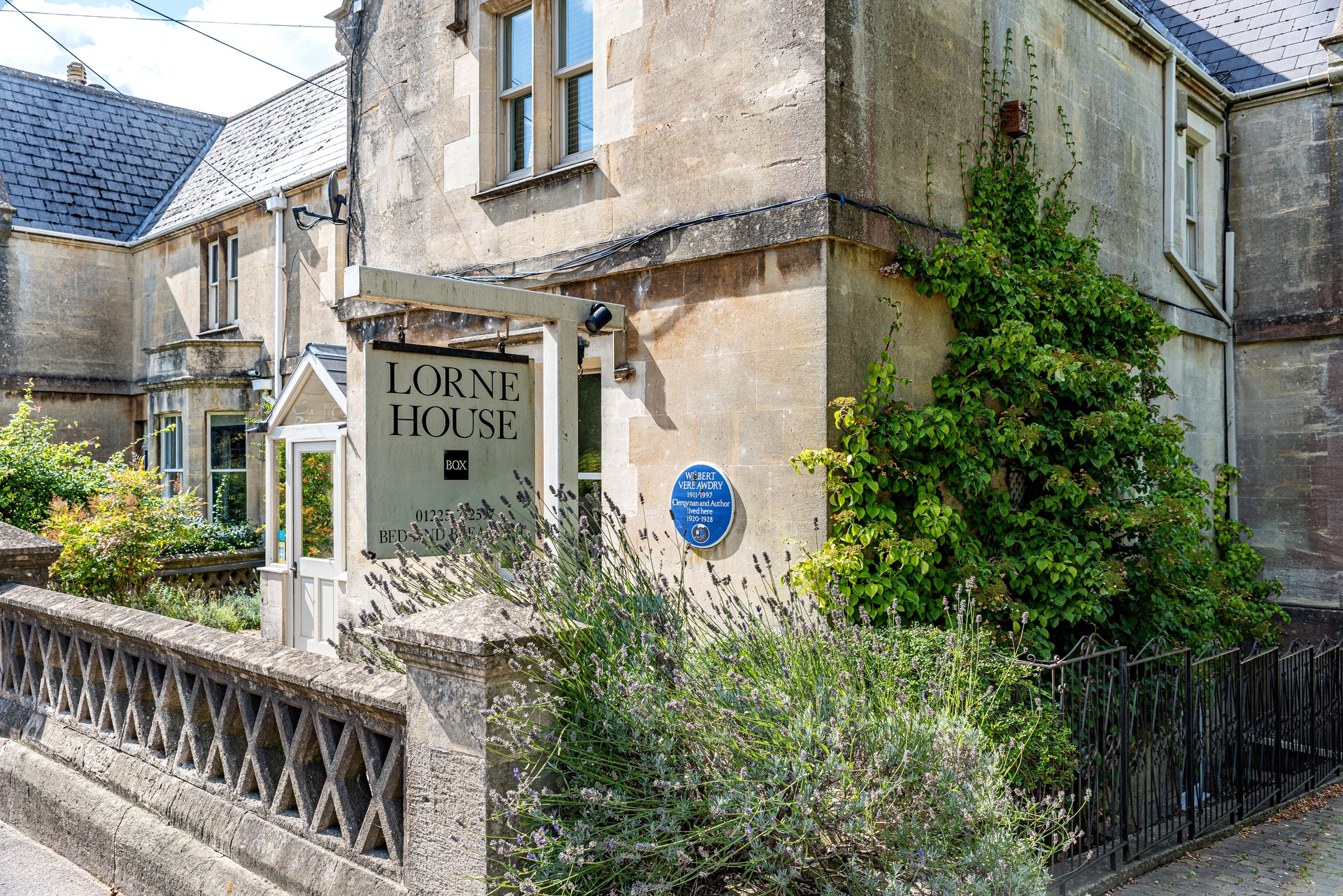 Lorne House sign beside the front entrance and stone boundary wall